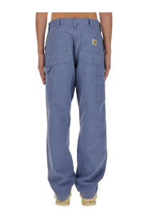 Back view of carhartt wip men’s single knee blue denim cargo pants with multiple pockets and logo patch on right pocket