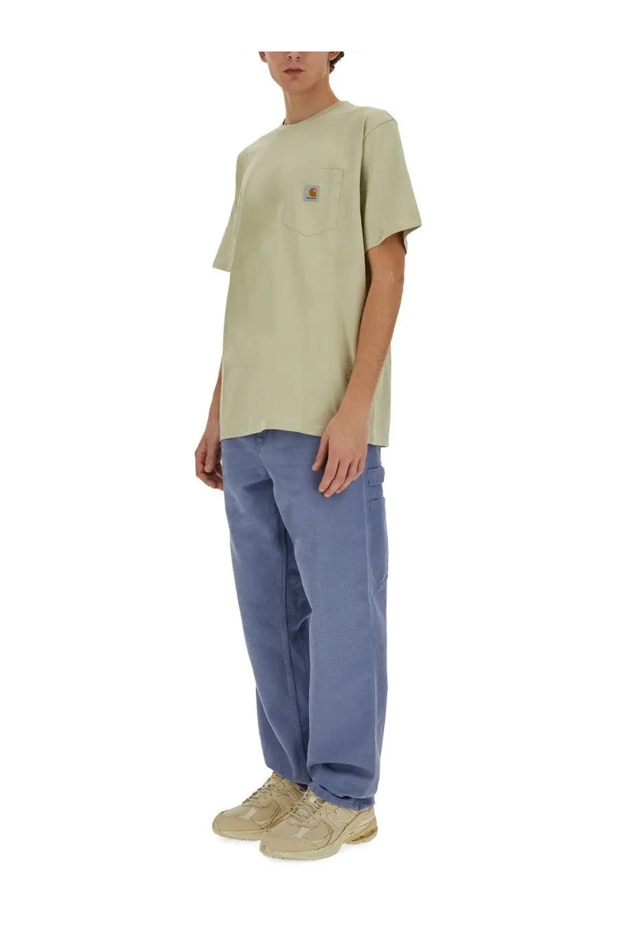 Carhartt Wip men’s single knee blue pants paired with light green Carhartt t-shirt with chest pocket logo patch