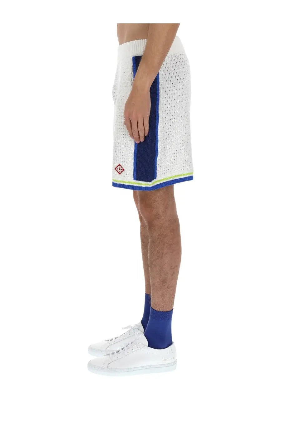 White mesh Casablanca men’s crochet basketball shorts with bold blue side stripe and lime green trim on hem and waistband
