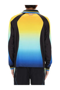 Casablanca men’s football shirt in a vibrant yellow to blue gradient with black sleeves and subtle blue piping accents