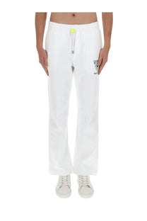 Casablanca men’s white cotton jogger pants with neon yellow drawstring tab and small embroidered logo on thigh