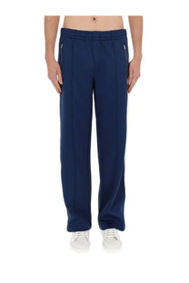 Casablanca men’s navy blue tapered track pants with white side stripes and zipper pockets designed for comfort