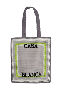 Gray crocheted unisex tote bag with lime green and white border details and casa blanca embroidery in black