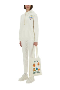Cream-colored canvas tote bag with colorful embroidered patches and casa blanca lettering for casual use