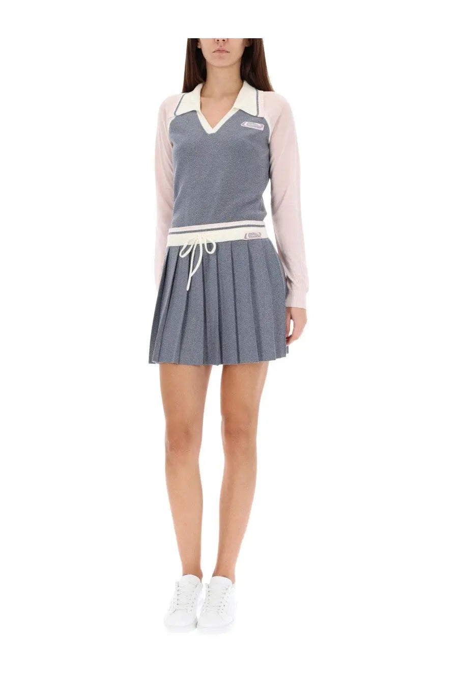 Casablanca women’s long sleeve tennis polo shirt in silver with cream collar paired with gray pleated skirt and white drawstring waistband