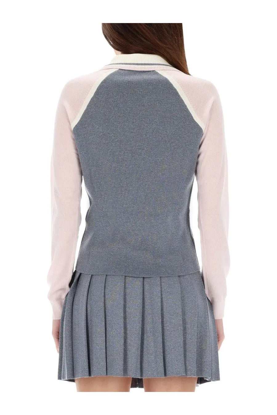 Casablanca women’s long sleeve tennis polo shirt in silver with a gray pleated skirt and pale pink contrasting sleeves