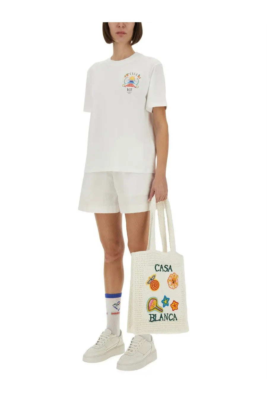 White canvas tote bag with colorful embroidered patches and casa blanca print for casual use
