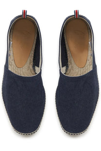 Navy blue canvas espadrilles with woven jute sole and red white blue striped pull tab at the heel by castañer