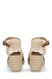 Beige woven espadrille wedge sandals with brown leather straps and buckle details by castañer women