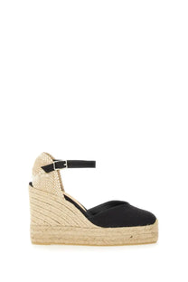 Castañer women’s black espadrille wedge sandal with woven jute sole and ankle strap shown from the back side
