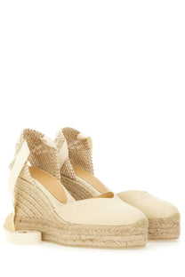 Cream-colored Castañer women’s espadrille wedge sandals with woven jute soles and matching fabric straps