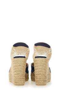 Castañer women’s espadrille wedge sandals with beige braided jute soles and navy blue fabric accents