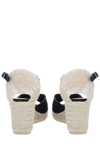 Castañer women’s espadrille wedge sandals in beige woven material with black fabric straps and buckle details