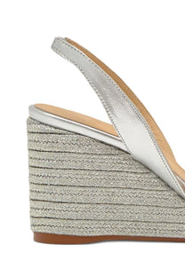 Castañer women’s silver leather slingback wedge sandal with textured woven espadrille-style heel shown from the back