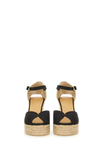 Black suede espadrille wedge sandals with woven jute platform and ankle strap by Castañer women’s sandalwood white black
