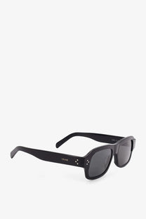 Black celine men’s acetate sunglasses with dark gray lenses and rectangular frame accented by white dots on temples