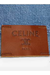Brown leather celine paris label with embossed logo and stitching on celine men’s blue denim jacket blue