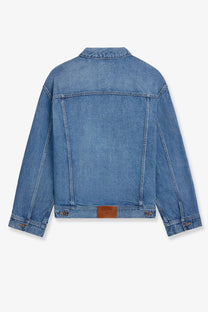 Back side of celine men’s blue medium-wash denim jacket with classic collar stitched seams and brown leather patch