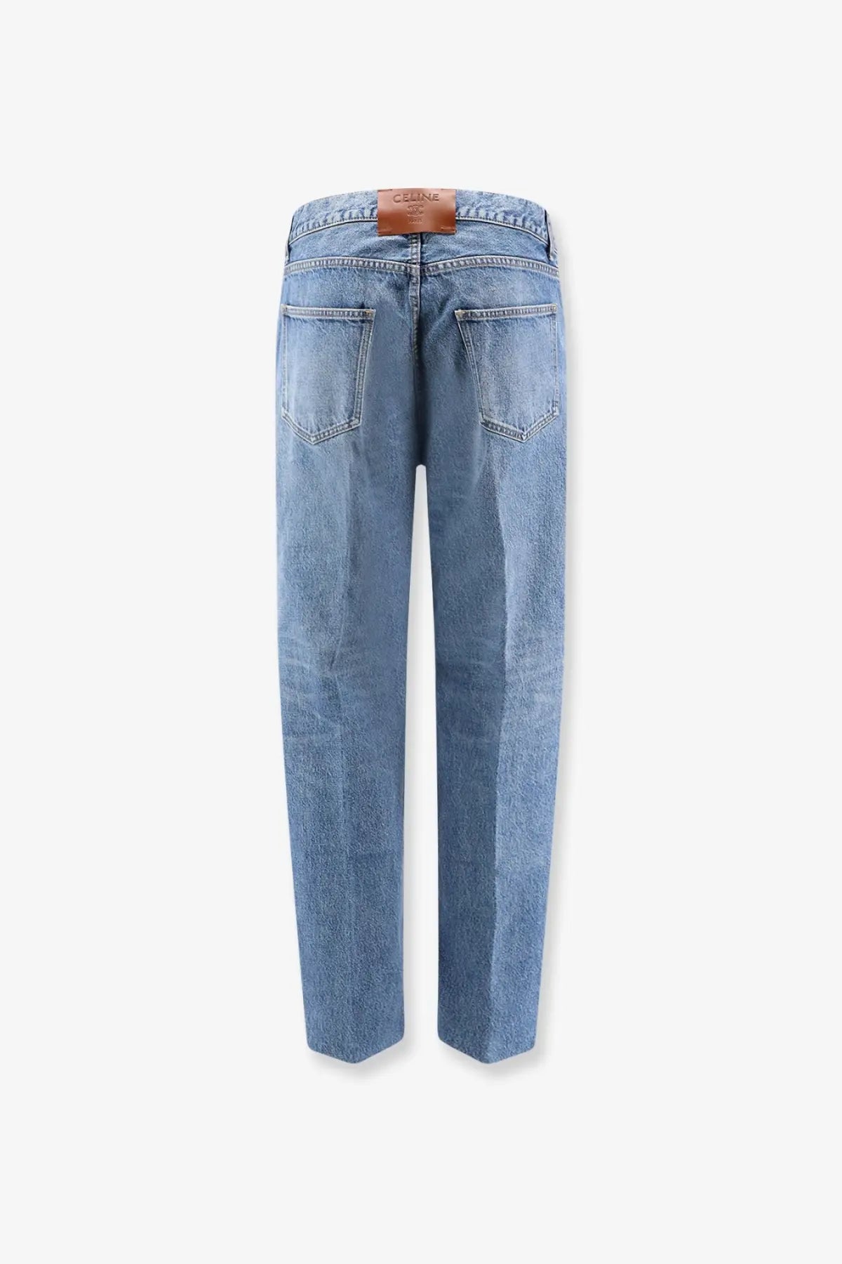 Light-wash Celine men’s boyfriend denim jeans in blue with a brown leather brand patch at the waistband back side