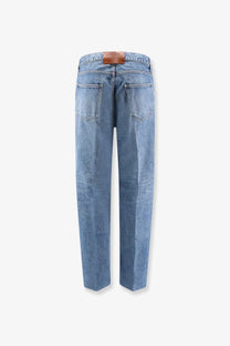 Light-wash Celine men’s boyfriend denim jeans in blue with a brown leather brand patch at the waistband back side
