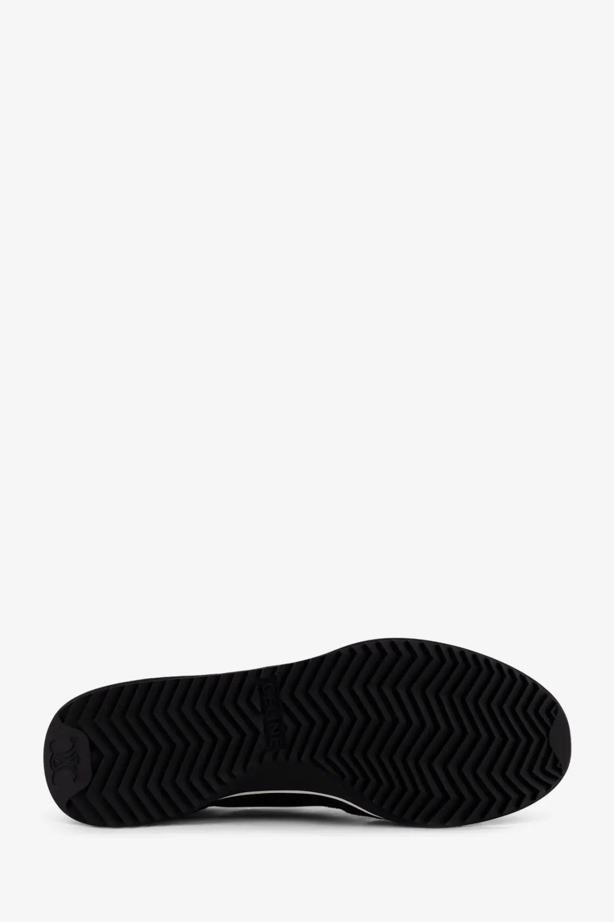 Back of celine men’s racer black nylon sneakers showing black rubber sole with zigzag tread pattern and embossed logo