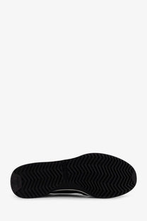 Back of celine men’s racer black nylon sneakers showing black rubber sole with zigzag tread pattern and embossed logo