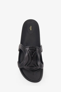 Black Celine men’s triomphe leather slide sandal with glossy sculpted strap and embossed geometric design