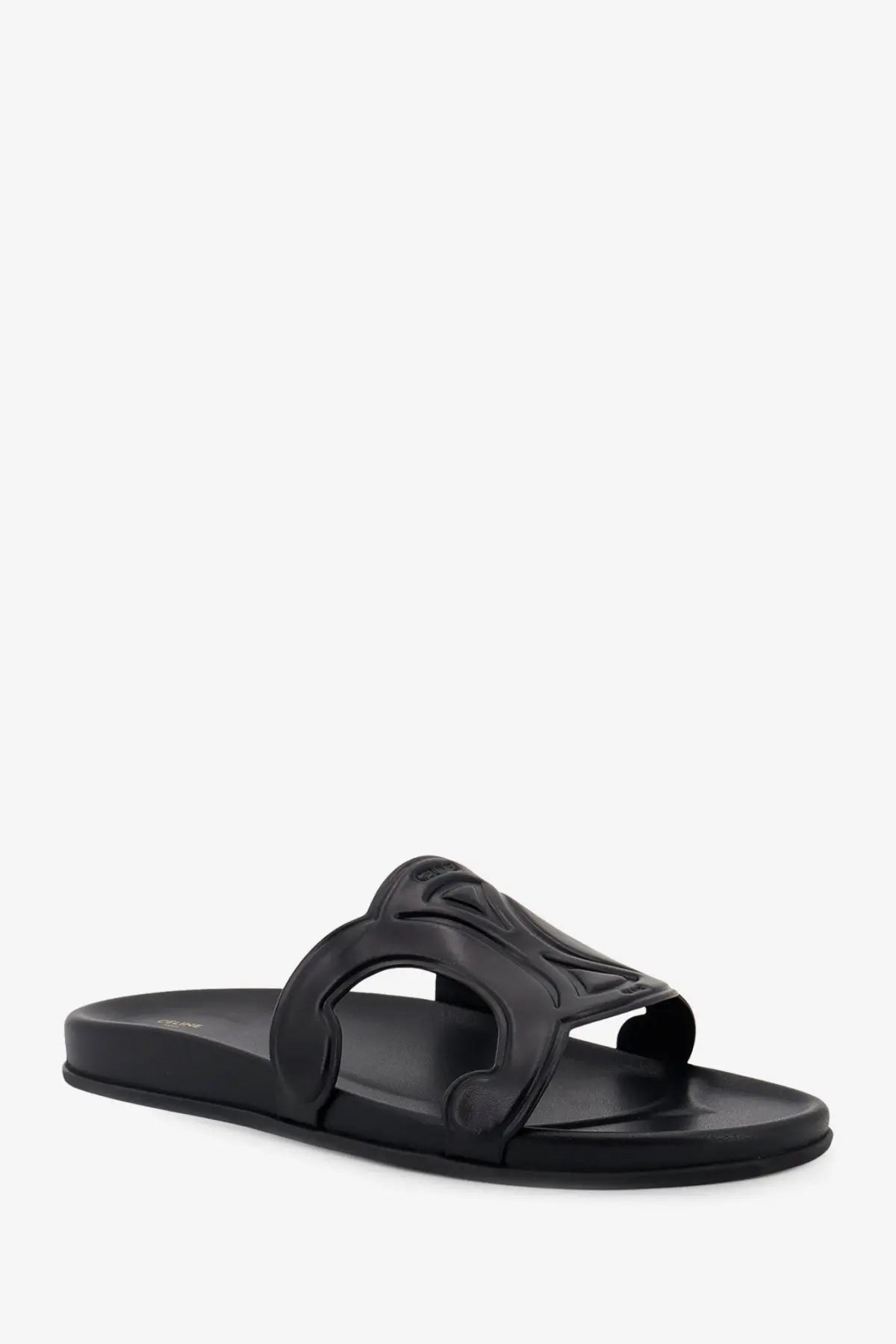 Black leather slide sandal featuring an ornate embossed strap design from celine men’s triomphe collection