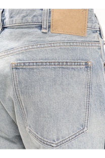 Back side of celine men’s wesley zuma wash denim jeans in light-wash denim with classic pocket stitching and tan leather patch