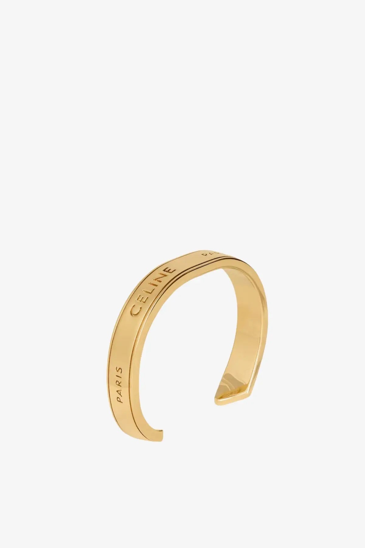 Gold-tone celine paris open cuff brass bracelet with sleek minimalist design for women