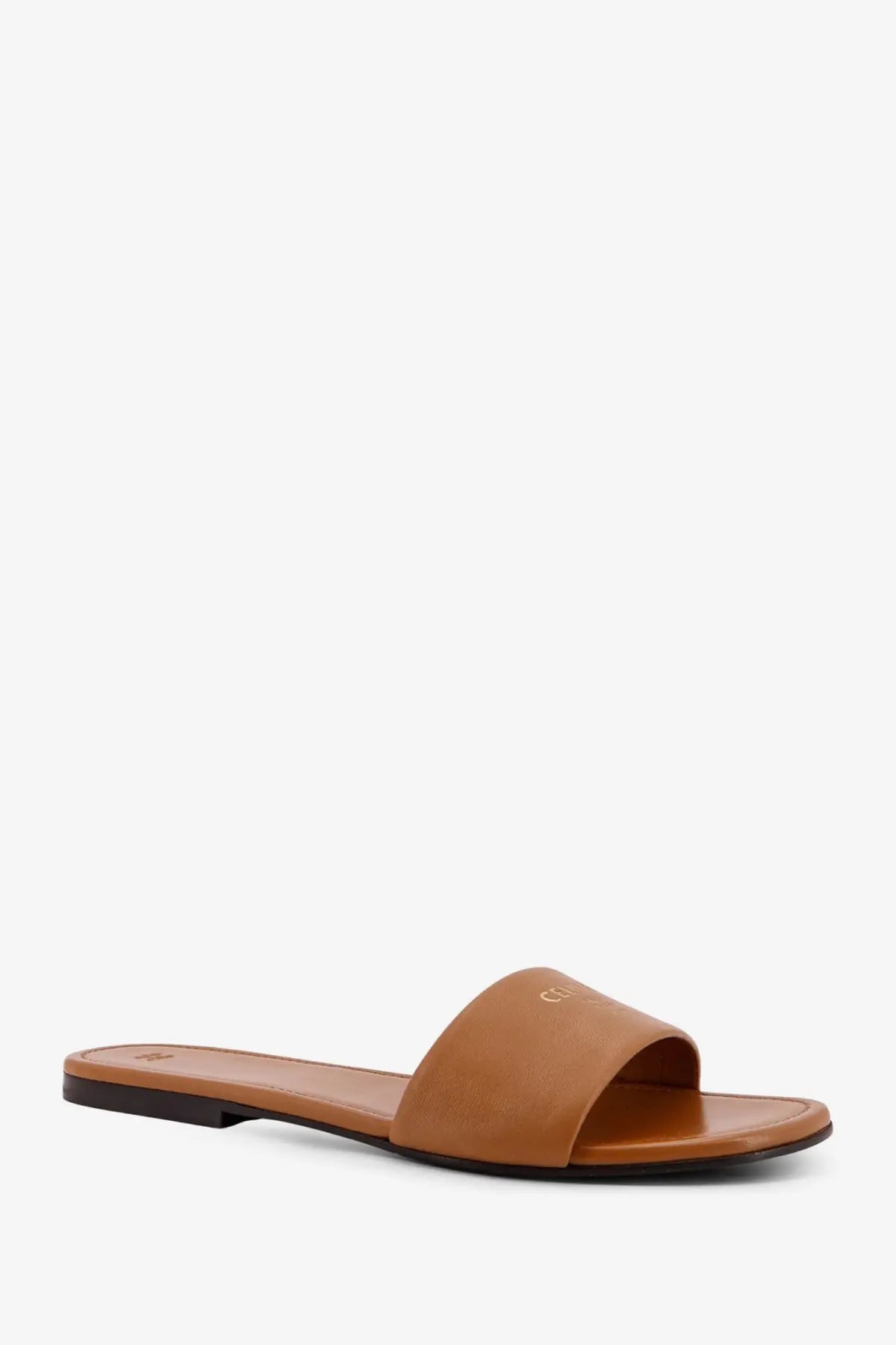 Tan leather slide sandal with minimalist design and subtle branding on strap celine women’s coast mule sandal sahara