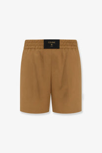 Celine womens tan cotton and linen shorts with a black waistband featuring the brand logo in front view