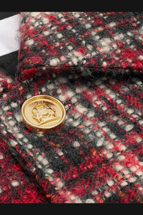A gold-toned circular button with embossed lion emblem and paris inscription on celine white cotton mohair blazer