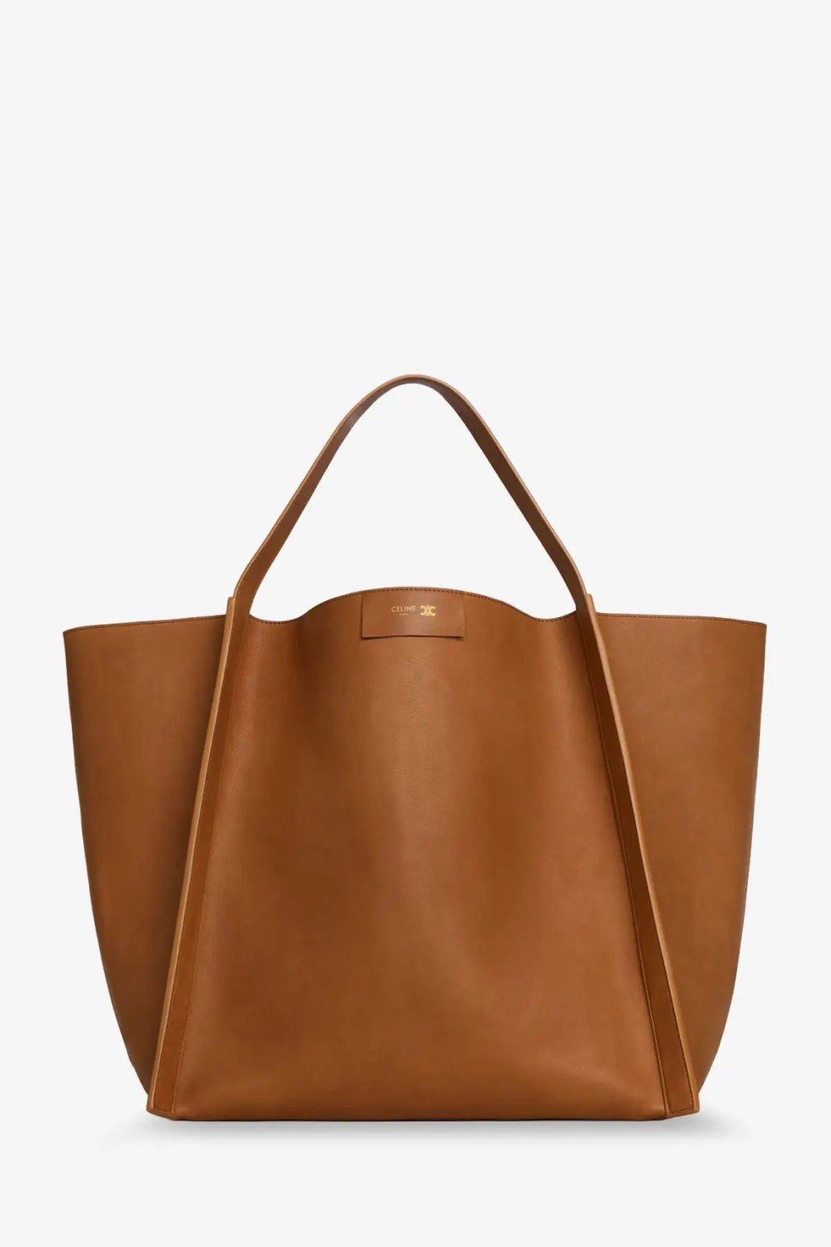 A sleek caramel-colored leather tote bag with minimalist design and subtle brand plaque celine women’s cube beige