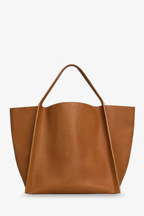 Celine women’s cube leather handbag beige featuring a sleek tan leather tote with clean lines and structured handles