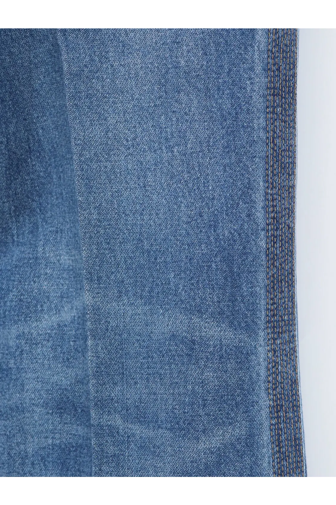 Blue denim fabric with textured weave and visible stitching on the seam of celine womens flared cotton jeans brown