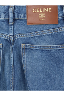Blue denim flared cotton jeans with a brown leather celine paris brand patch on the back side