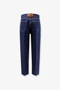 Dark blue denim celine women’s jeans with a brown leather brand patch at the waistband back view