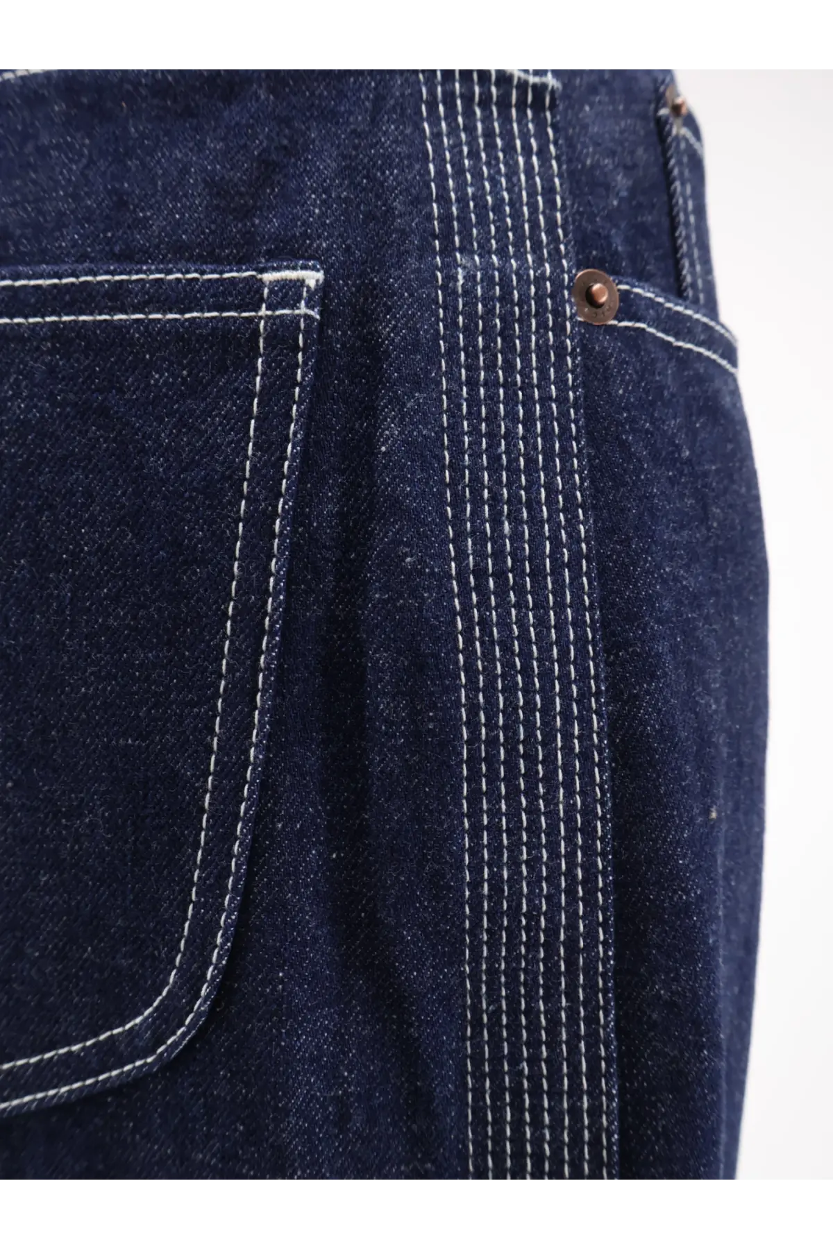 Celine women’s dark indigo denim jeans with contrasting white stitching and copper-toned button light rinse