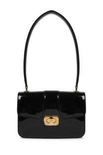 Celine women’s Josephine bag black patent leather with gold-tone clasp and curved top handle visible from front