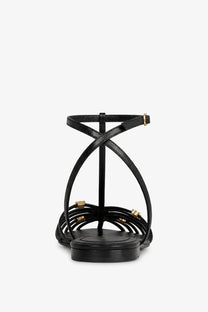 Black leather strappy cage sandal with gold tone hardware accents from Celine womens collection
