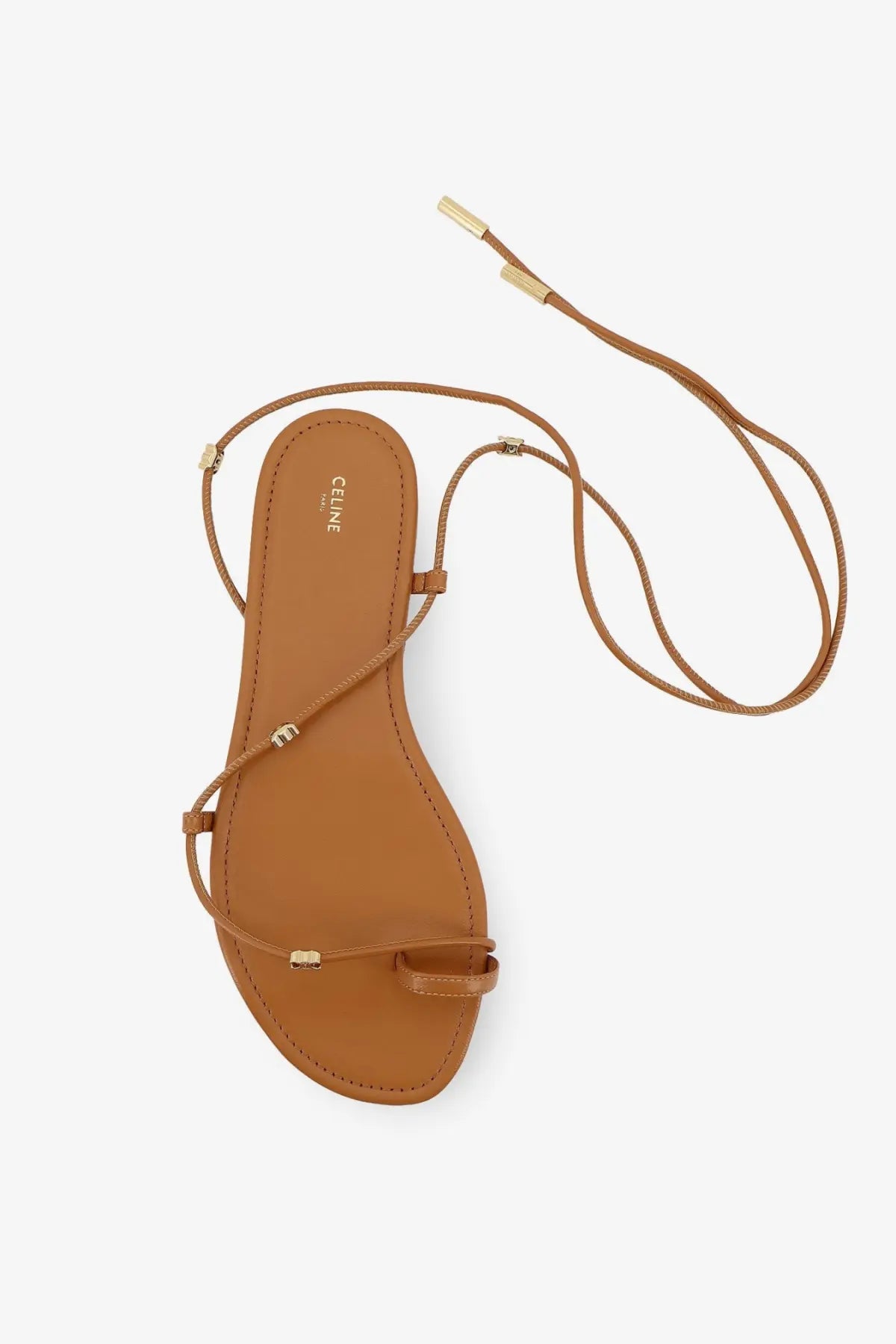 Tan leather celine women’s sandal with gold-tone hardware and adjustable ankle straps in sahara style