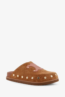 Brown suede slip-on mule with tan leather logo patch and metallic studs along the side by Celine women