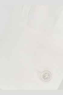 White button engraved with celine paris on a relaxed white cotton shirt for women