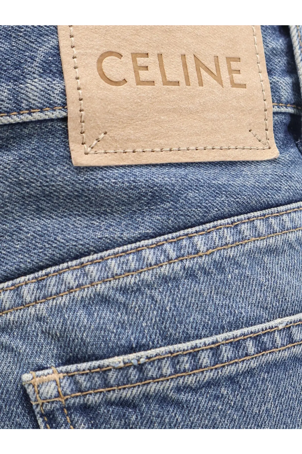Beige leather celine patch stitched on medium-wash blue denim in celine women’s stone washed cotton jeans red back view