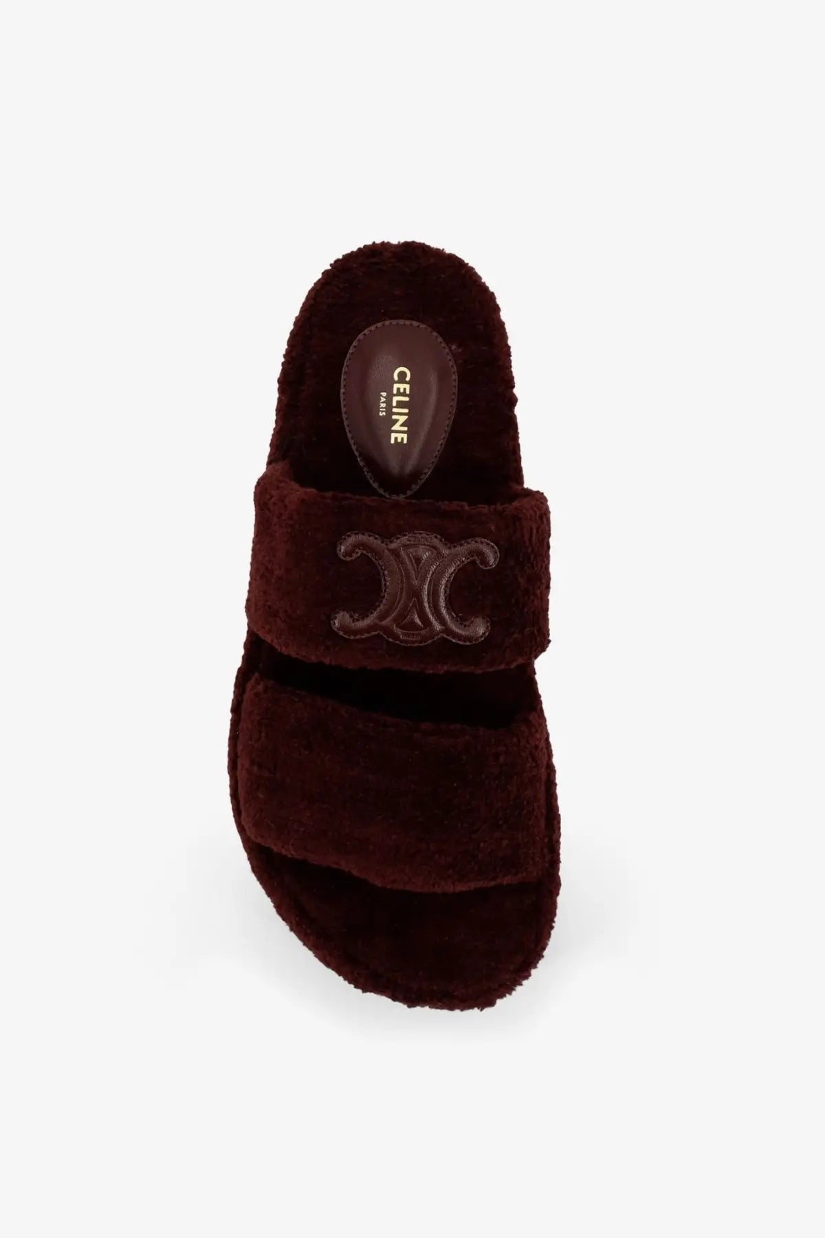 A plush deep burgundy celine womens slide sandal with fuzzy shearling texture and embossed logo on the strap