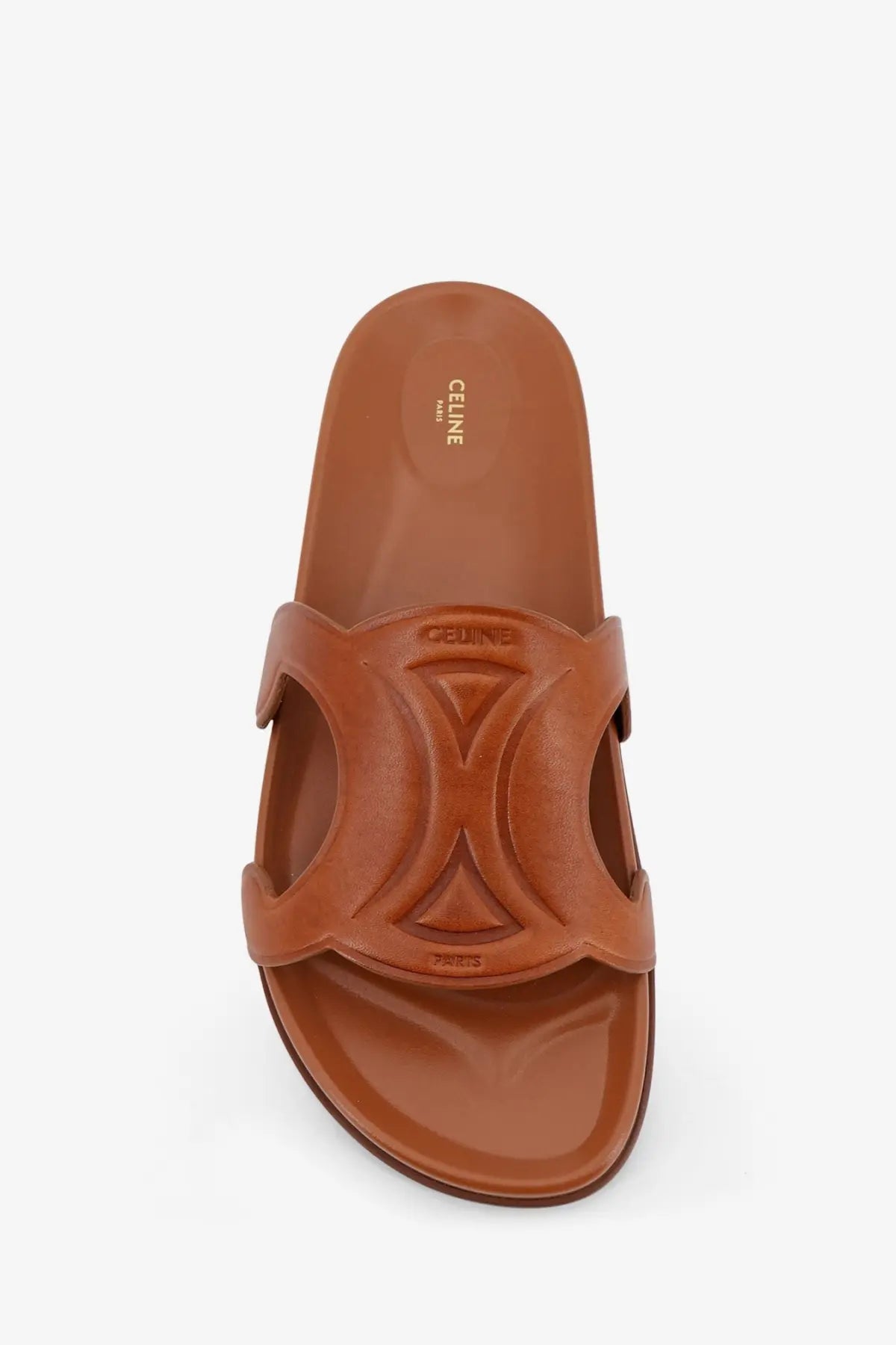 Brown leather Celine women’s Triomphe slide sandal with distinctive embossed x-shaped strap design in beige