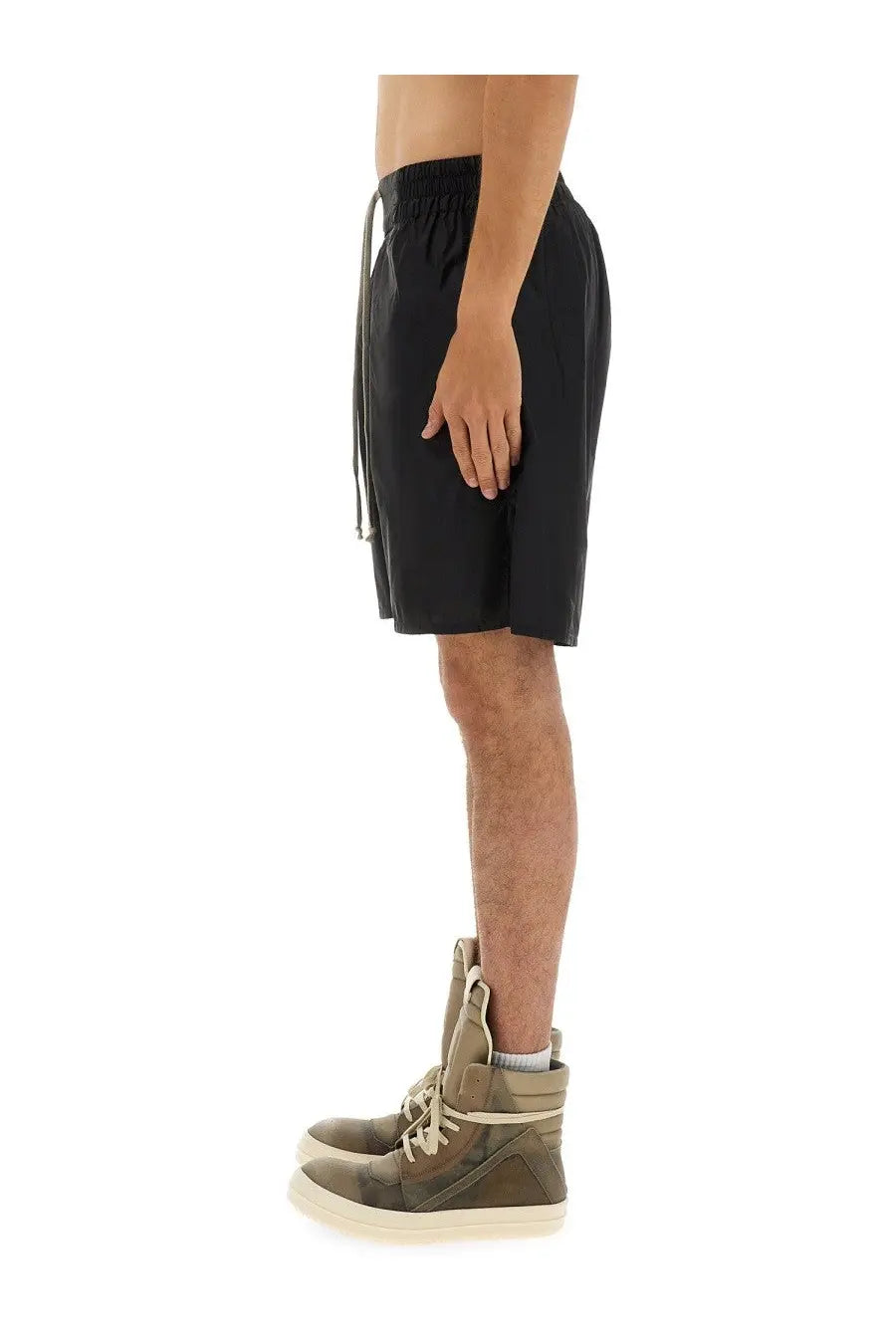 Black champion x rick owens men’s nylon shorts with elastic waistband and drawstring paired with olive green sneakers