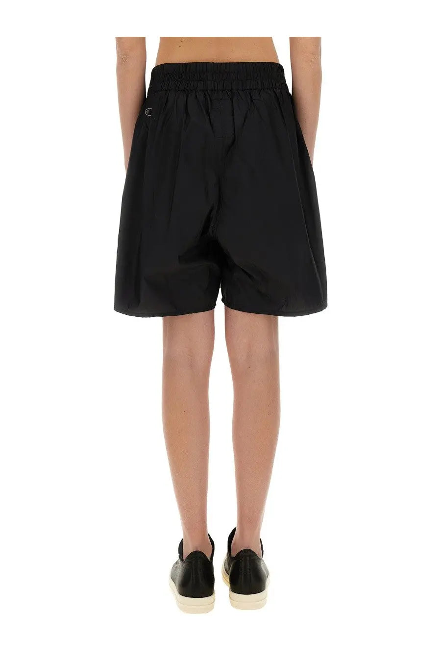 Back view of black champion x rick owens women’s shorts with elastic waistband and small logo on back pocket