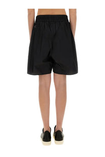 Back view of black champion x rick owens women’s shorts with elastic waistband and small logo on back pocket